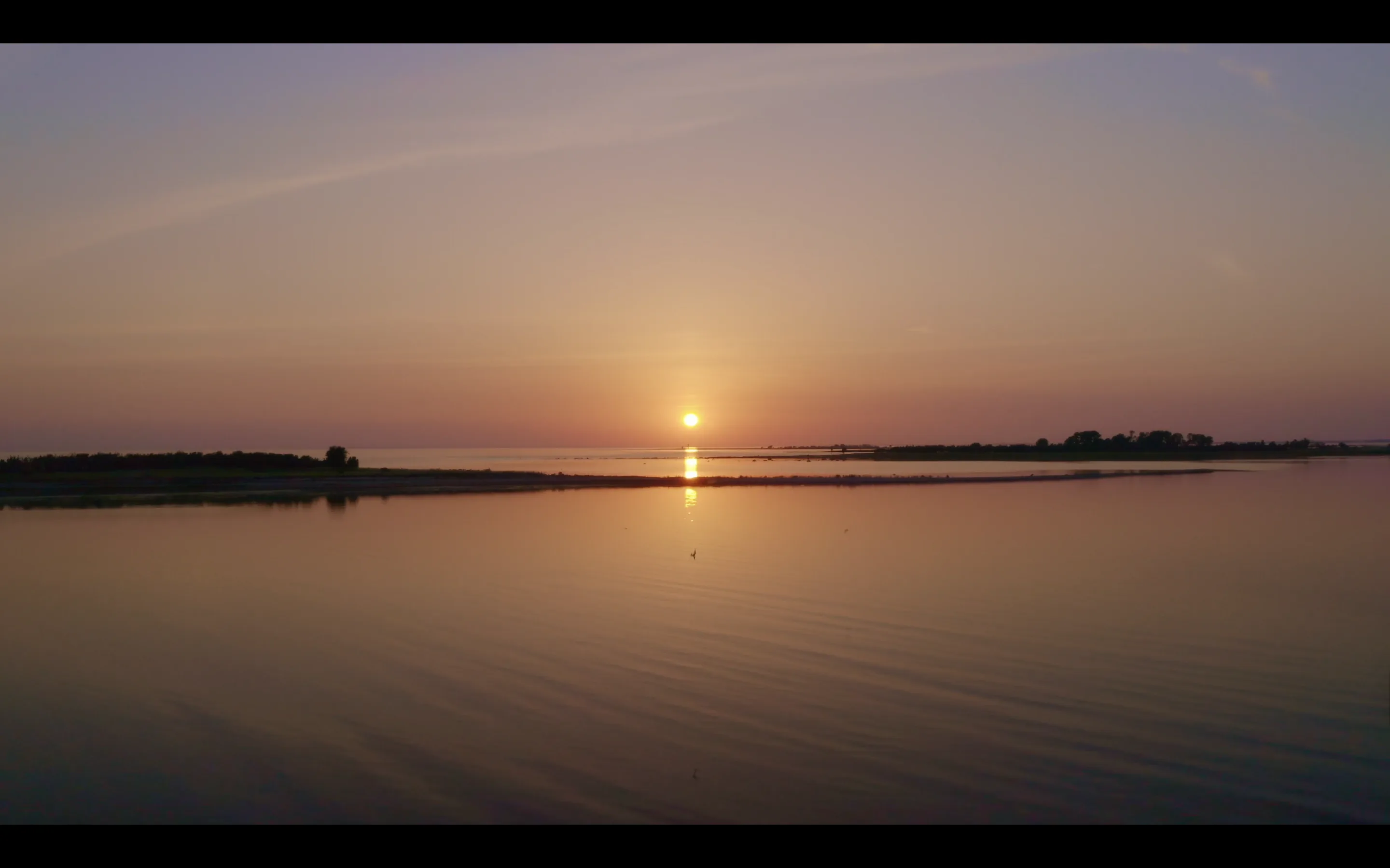 A calm sunset reflected over still water — the feeling of inner clarity